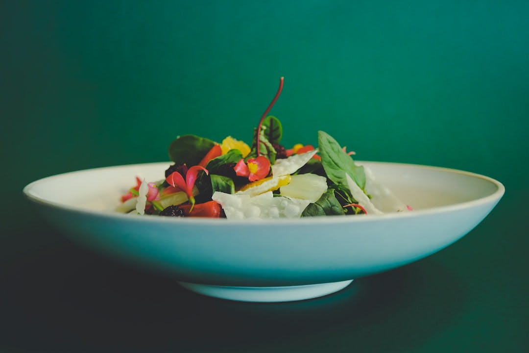 vegetable salad on white ceramic bowl